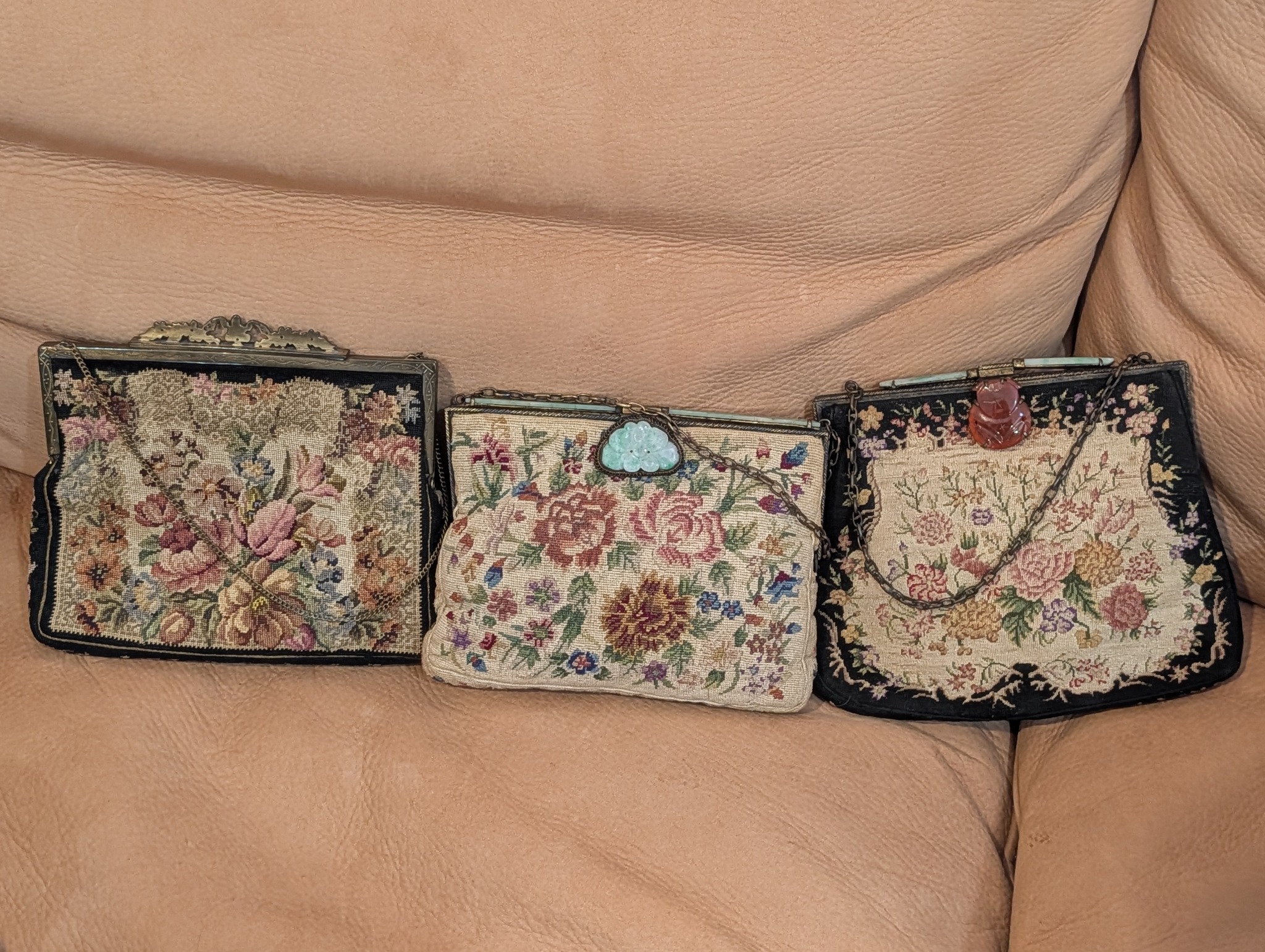 Three floral handbags with decorative clasps