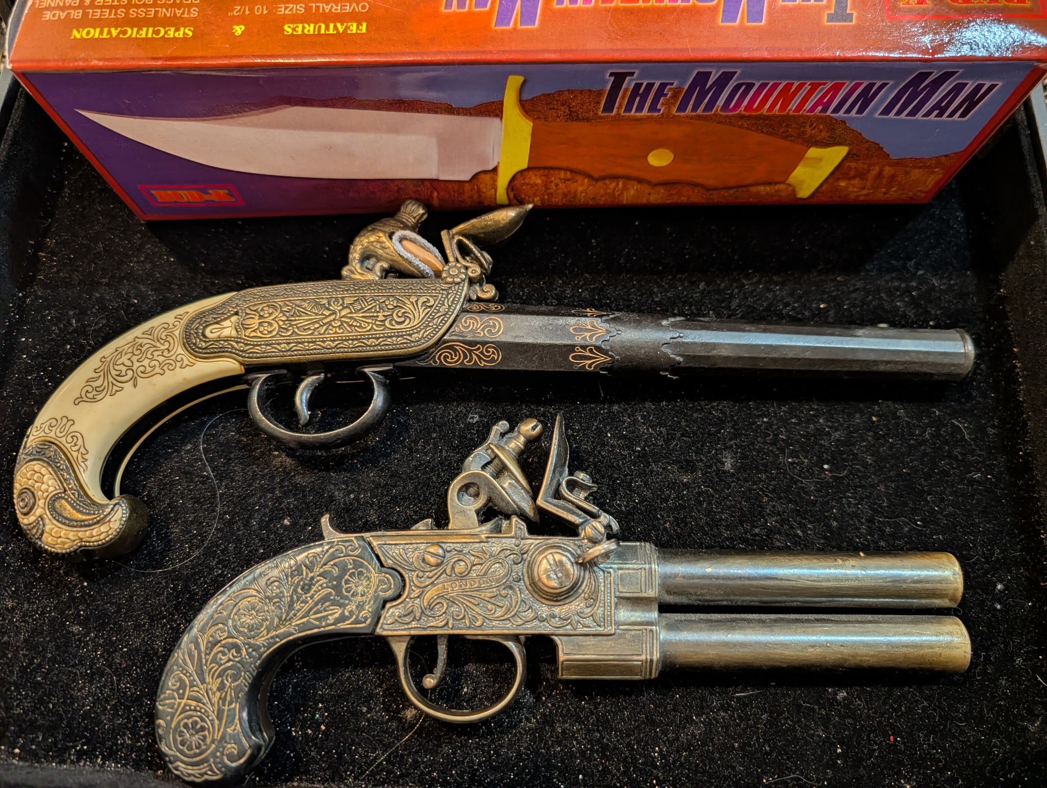 Ornately decorated pistol-shaped collectibles